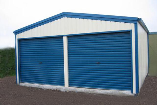 A white building with blue roller doors